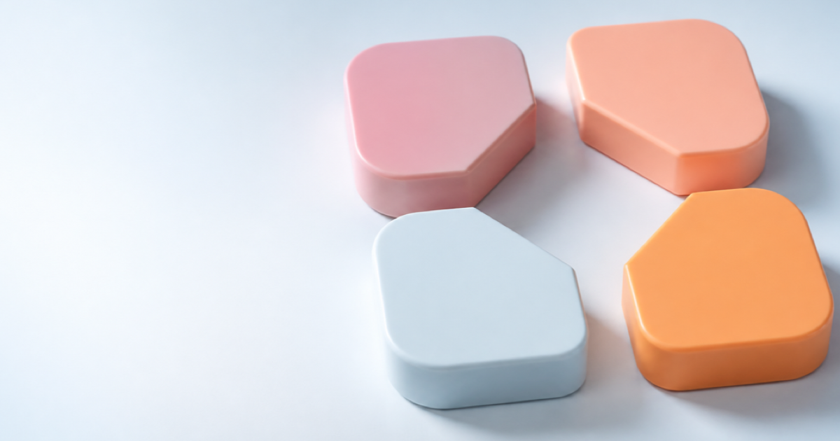 Four tactile puzzle pieces arranged on a pale blue surface.